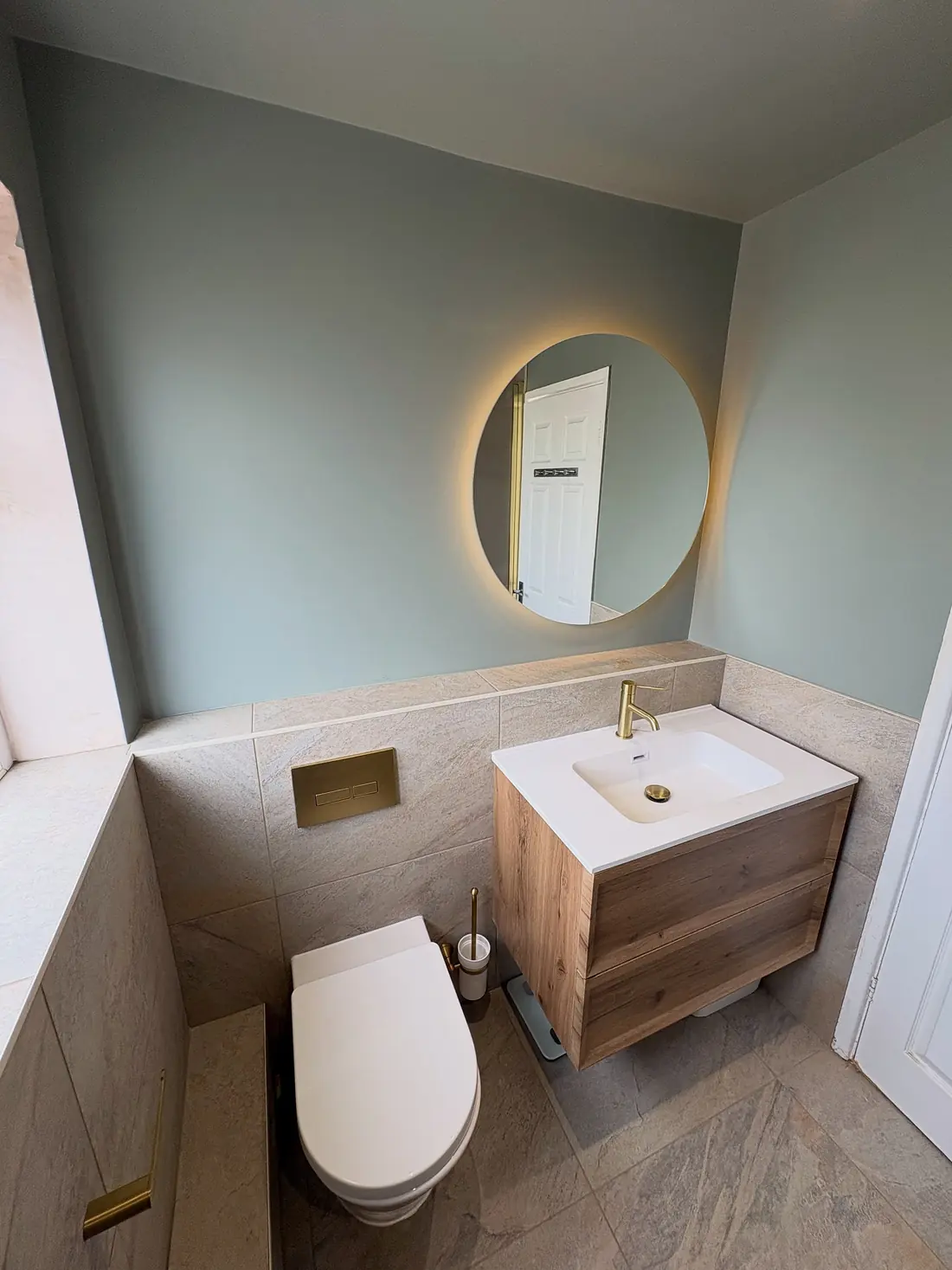 Sage green bathroom in Cholsey with a round backlit mirror, a brass tap and an oak wall-hung vanity