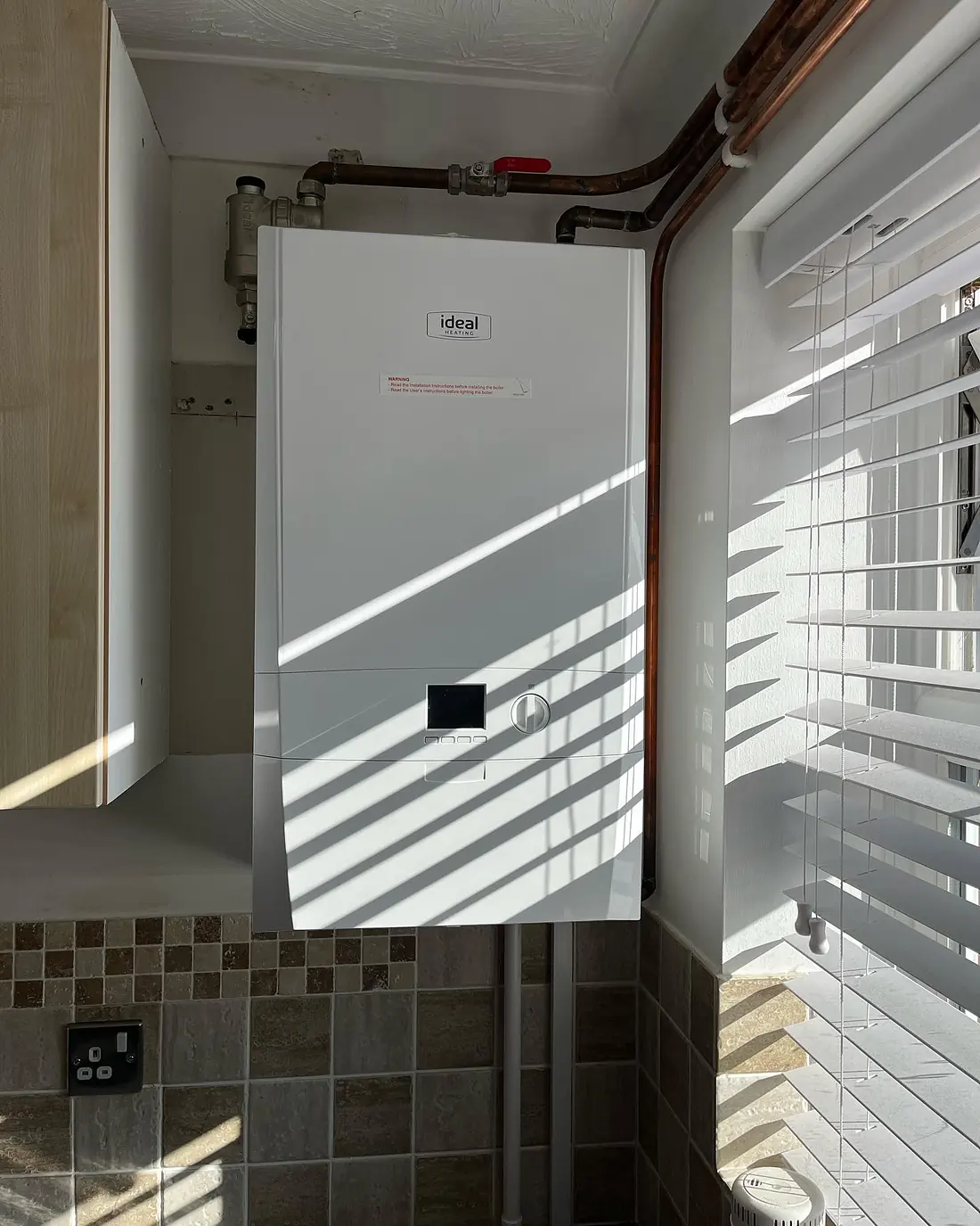 A new wall-mounted boiler with fresh copper pipework